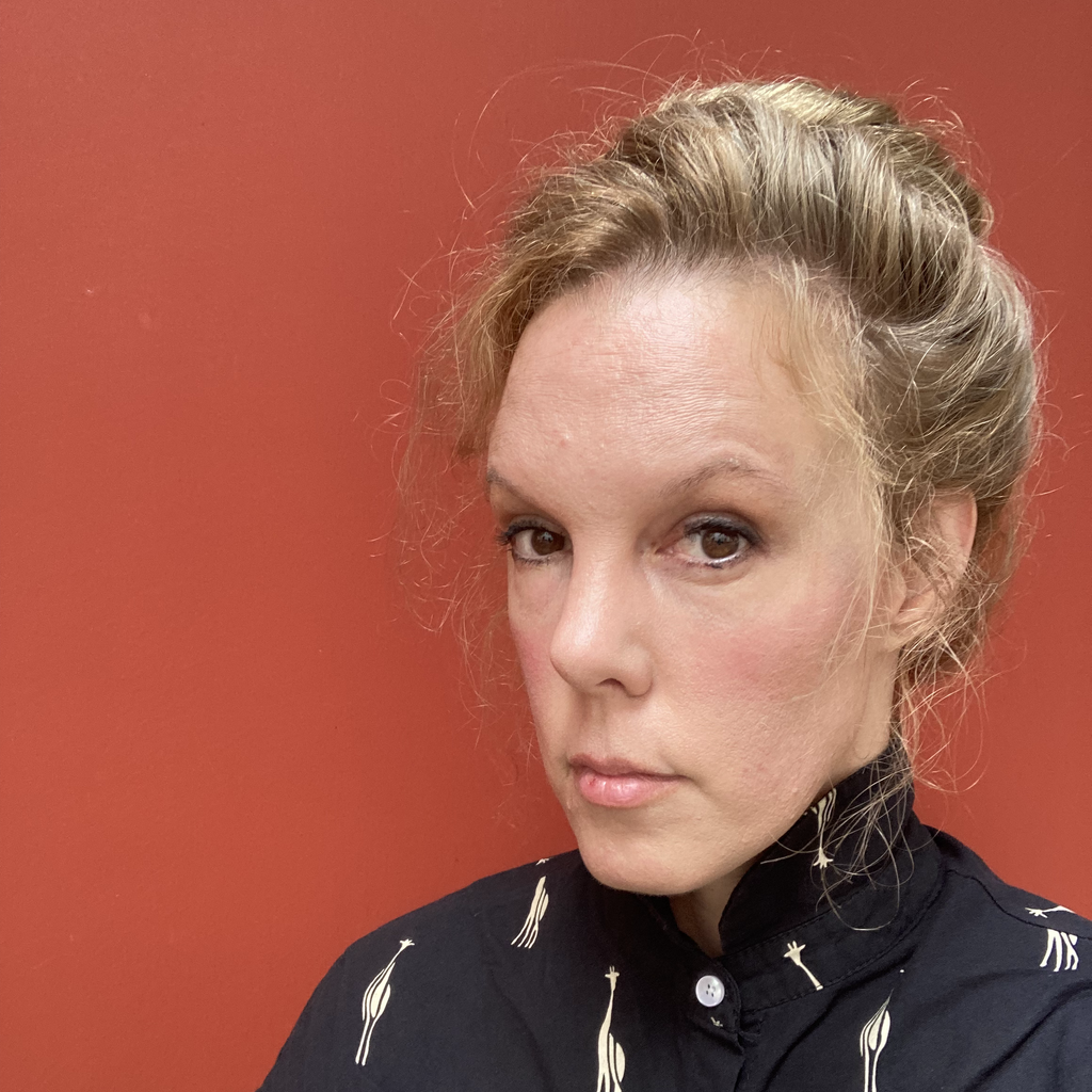 woman with blond hair against red background